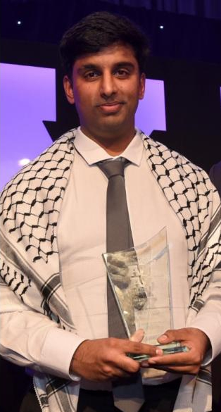 Photo of Haddi Malik receiving an award
